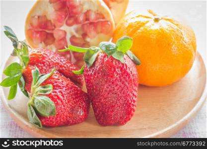 Easy meal mix fruit on wooden plate, stock photo