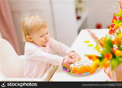 Eat smeared baby touched birthday cake by hands