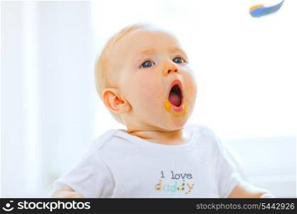 Eat smeared lovely baby girl open mouth for spoon&#xA;