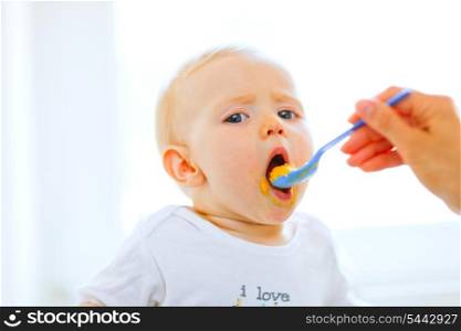 Eat smeared pretty baby girl open mouth for spoon&#xA;