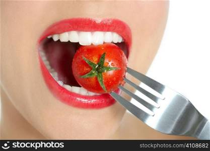 Eating a red tomato macro of woman teeth and red lips mouth