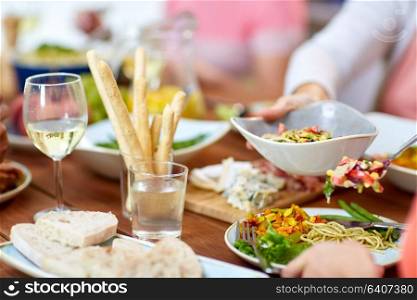 eating and leisure concept - people putting salad on plate with food. people putting salad on plate with food