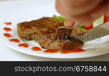 Eating Grilled Beef Steak On A Plate