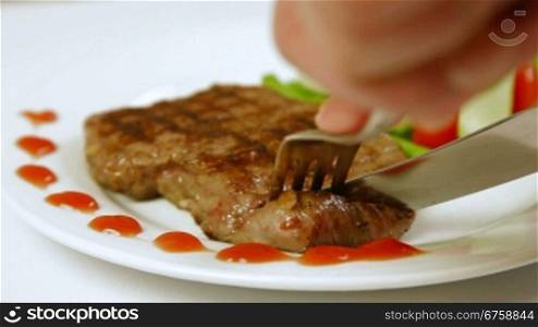 Eating Grilled Beef Steak On A Plate