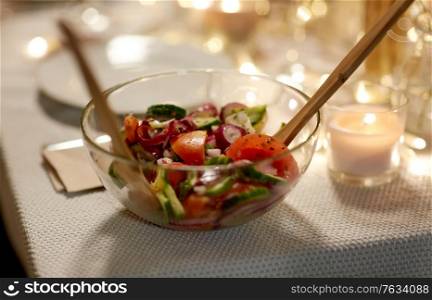 eating, holiday and food concept - vegetable salad on served table at home dinner party. vegetable salad on table at home dinner party