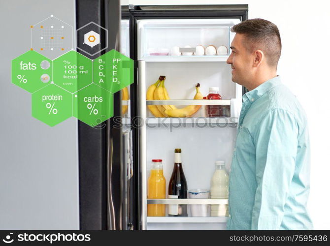 eating, people and diet concept - happy smiling middle-aged man looking for food in fridge at kitchen over nutritional value chart. man looking for food in fridge at kitchen