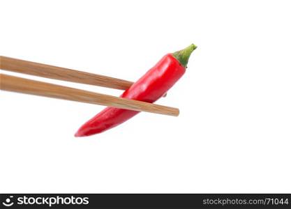 eating red hot pepper with chopsticks isolated on white background