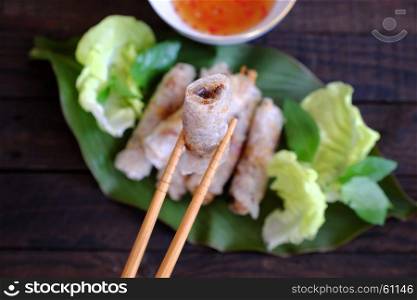 Eating spring roll pastry or cha gio is popular food at Vietnam cuisine, stuffing from meat and wrapper by rice paper, then deep fried, eat with salad and fish sauce