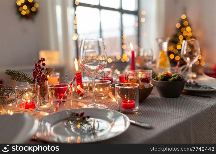 eating, winter holidays and celebration concept - close up of table serving for christmas dinner party at home. table serving for christmas dinner party at home