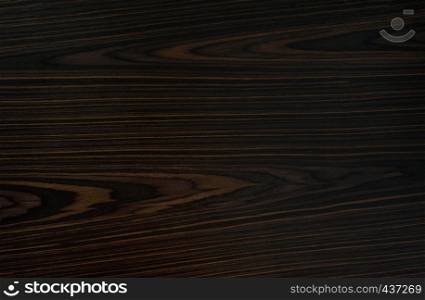 Ebony background - black, dark, expensive wood.