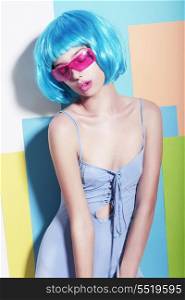 Eccentric Extravagant Woman in Styled Blue Wig and Pink Sunglasses