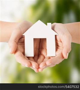 eco, bio, home, nature, power saving concept - woman hands holding house