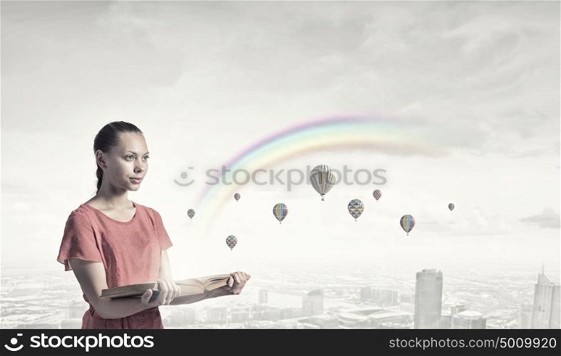 Eco city concept. Young woman in red dress holding opened book