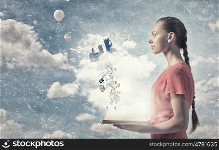 Eco city concept. Young woman in red dress holding opened book with city model