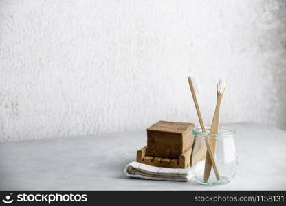 Eco-friendly bamboo toothbrushes in a glass jar and handmade organic soap mock up. Zero waste, No plastic, Reuse, Reduce, Recycle, Sustainable lifestyle concept