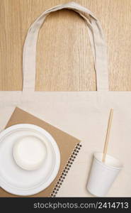 Eco friendly concept, Eco bag with food container on wooden background.