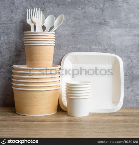 Eco friendly food packaging on table background. natural container: cup, plate, spoon and fork. zero waste, pollution, earth day, free plastic, world Environment day concept