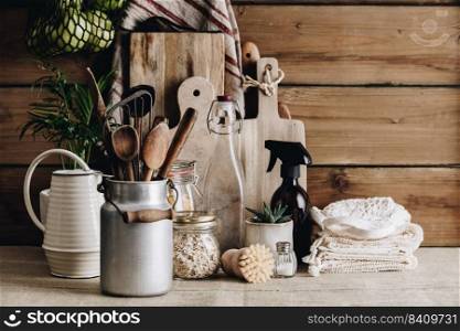 Eco-friendly kitchen concept: Kitchen cooking utensils, house plants, water can, linen towel, and cooking ingredients in glass jars against rustic kitchen wall, front view