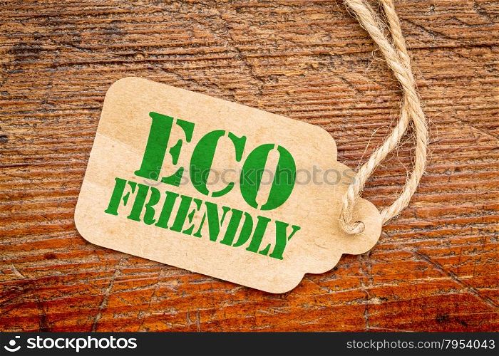 eco friendly sign a paper price tag against rustic red painted barn wood - shopping concept