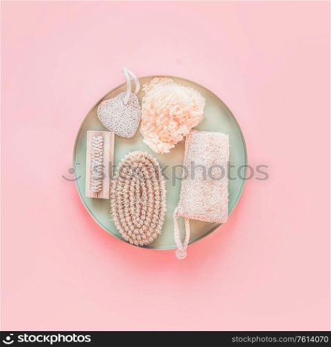 Eco friendly skin care and spa accessories on tray at pastel pink background, top view. Zero waste . Modern beauty concept. Blog layout. Plastic free. Natural body treatment equipment