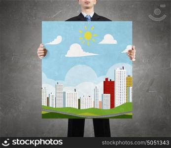 Eco life concept. Businessman holding banner with eco city concept