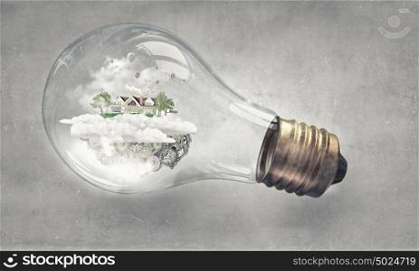 Eco life. Eco house and energy saving concept in glass light bulb