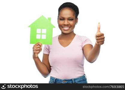eco living, environment and sustainability concept - happy smiling young african american woman holding green house showing thumbs up over white background. smiling african american woman holding green house