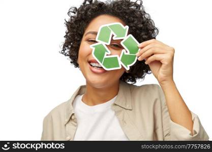 eco living, environment and sustainability concept - portrait of happy smiling woman looking through green recycling sign over white background. happy woman looking through green recycling sign