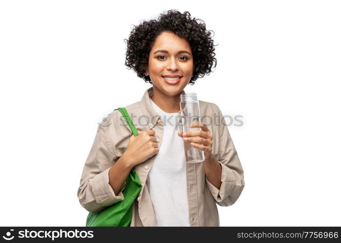 eco living, zero waste and sustainability people concept - happy smiling woman with water in reusable glass bottle and shopping bag over grey background. happy woman with water in glass bottle and shopper