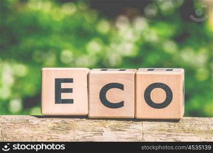 Eco sign made of wooden cubes in the forest
