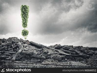 Ecology concept. Conceptual image with exclamation mark growing on ruins