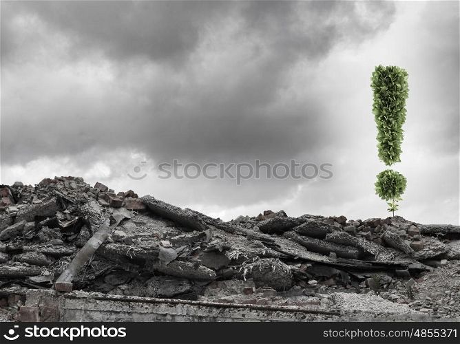 Ecology concept. Conceptual image with exclamation mark growing on ruins