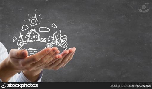 Ecology concept. Person hands holding chalk drawn eco life concept