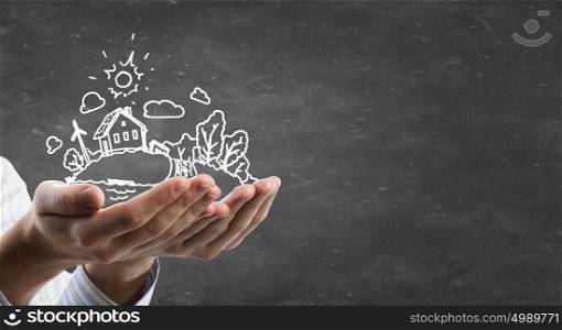 Ecology concept. Person hands holding chalk drawn eco life concept