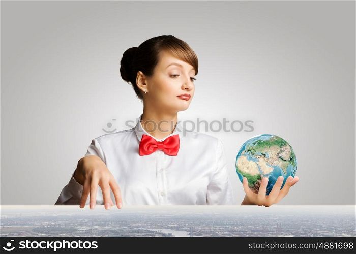 Ecology concept. Young smiling woman holding Earth planet in hand. Elements of this image are furnished by NASA