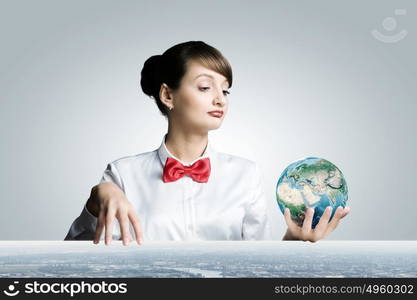 Ecology concept. Young smiling woman holding Earth planet in hand. Elements of this image are furnished by NASA