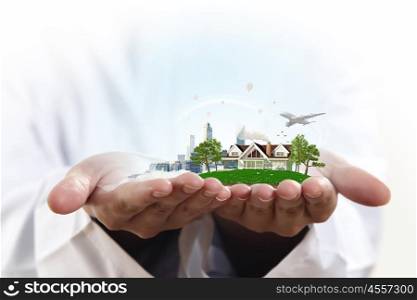 Ecology life concept. Male hands holding green life concept in palm