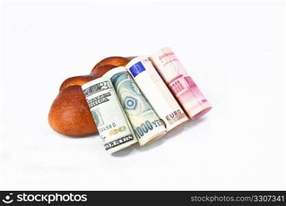 Economic basics are reflected in multiple world currencies, dollar, yen, euro, and yuan, placed against a basic loaf of bread.