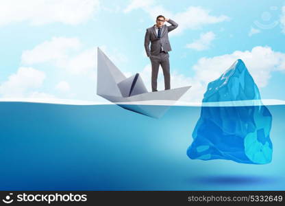 Economic crisis concept with businessman in sinking paper boat