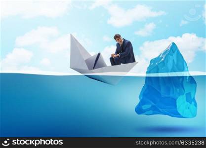 Economic crisis concept with businessman in sinking paper boat