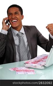 Ecstatic businessman with a briefcase full of money