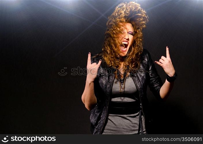 ecstatic woman is dancing to the rock music