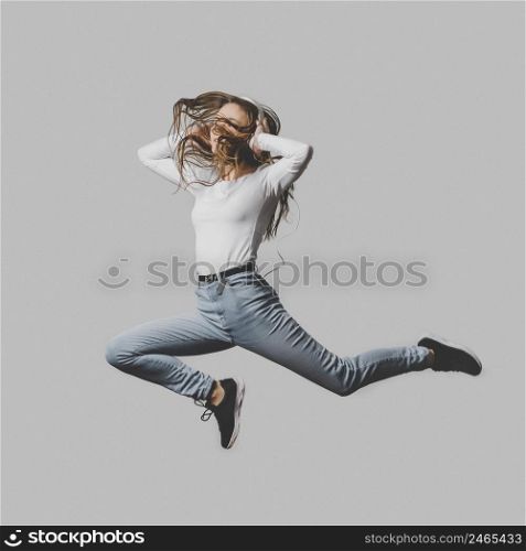 ecstatic woman with headphones jumping air