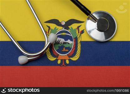 Ecuador flag and stethoscope. The concept of medicine. Stethoscope on the flag as a background.. Ecuador flag and stethoscope. The concept of medicine.