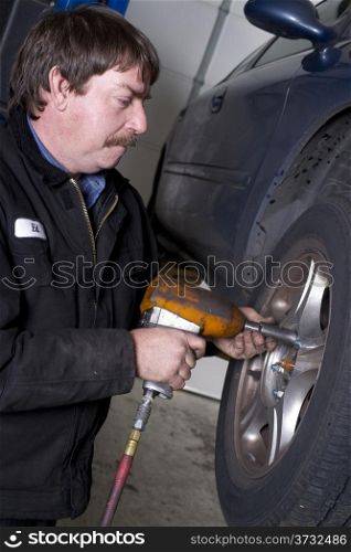 Ed takes the lug nuts off for a routine brake check