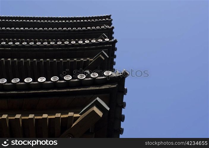Edge of a five storied pagoda seen from below. Edge of a five storied pagoda in Japan seen from below with blue sky background