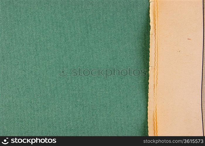 edge of the old newspaper on a green background