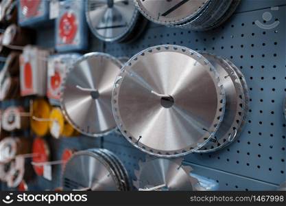 Edged discs for saws in tool store closeup, nobody. Choice of equipment in hardware shop, professional instrument in supermarket. Edged discs for saws in tool store closeup, nobody
