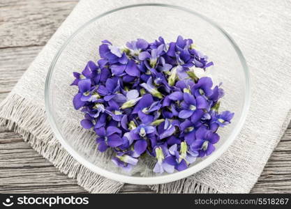 Edible violets in bowl. Foraged edible purple and white violet flowers in bowl