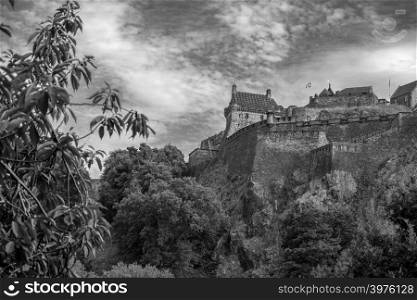Edinburgh, United Kingdom - July 27, 2018: Edinburgh Castle viewed from Princes Street Gardens in black and white.